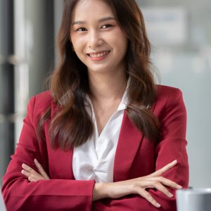 Beautiful Asian businesswoman working on a laptop computer doing financial, accounting analysis, reports, and data at the office.